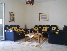 Aggeliki Apartment, Tolo - The lounge area which opens out onto the balcony